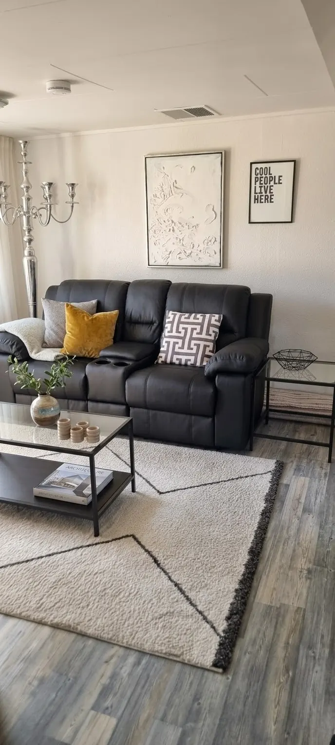 TV corner with a black leather recliner sofa and patterned rug